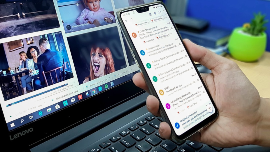 person-using-smartphone-and-laptop-computer-j6qn9se4akm